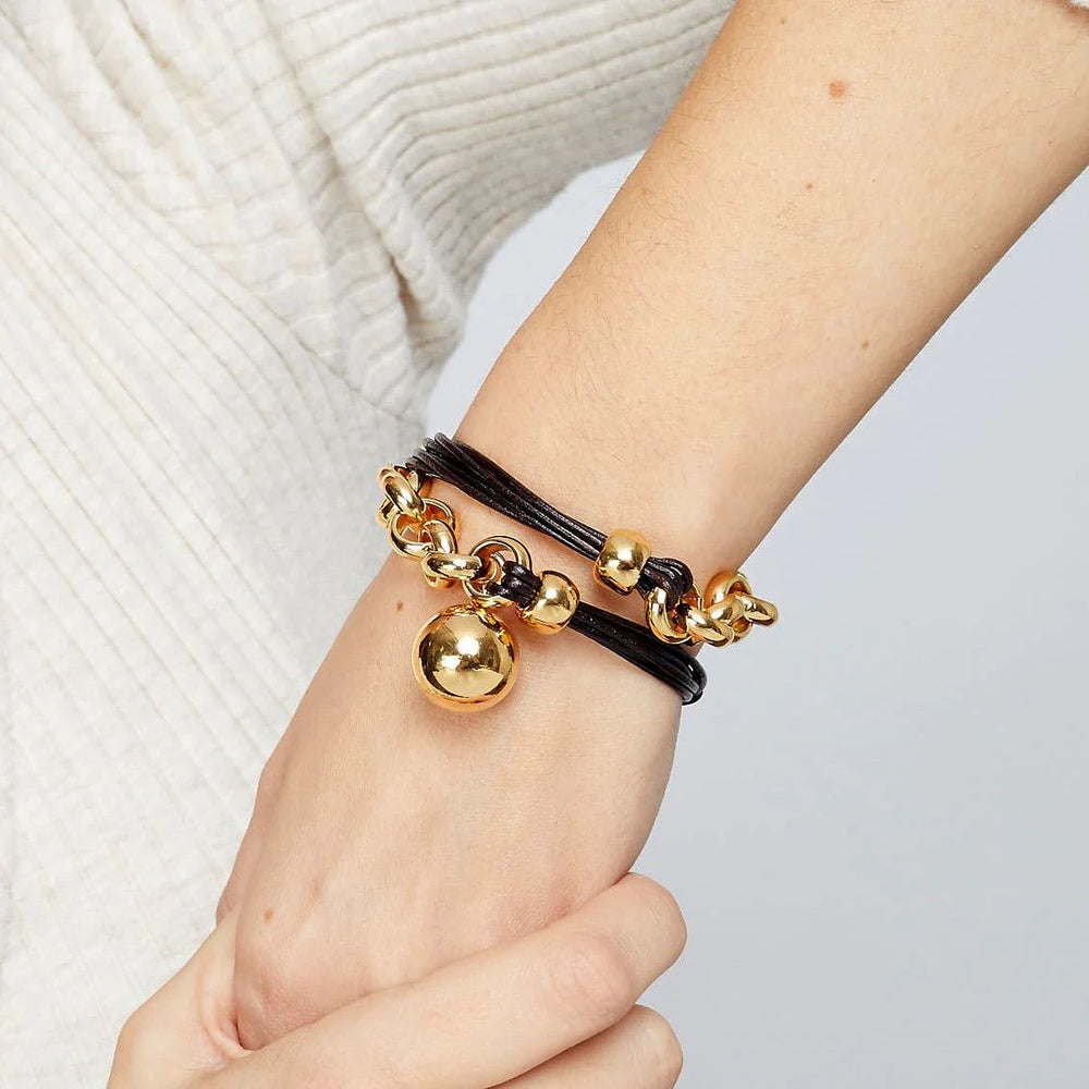 Leather cord and gold plated rolo chain bracelet with a hanging ball in the center