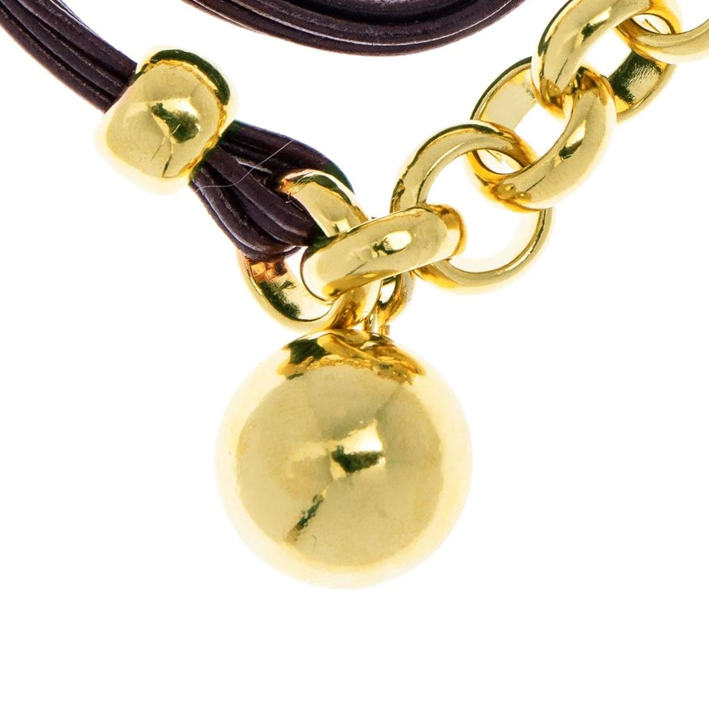 Leather cord and gold plated rolo chain bracelet with a hanging ball in the center