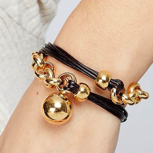 Leather cord and gold plated rolo chain bracelet with a hanging ball in the center